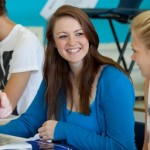students and tutor smiling and talking