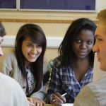 4 students smiling and discussing revision