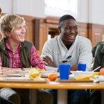4 students eating lunch together in cafeteria