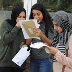 3 female students opening their results envelopes