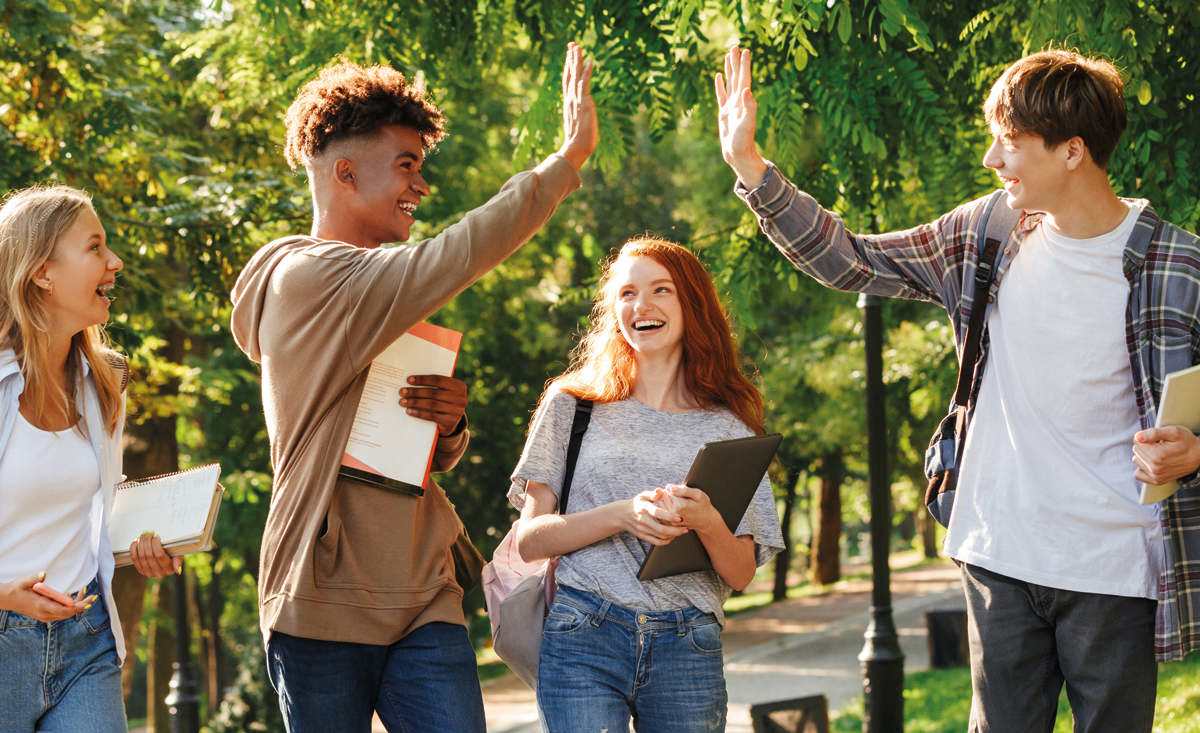 Students smiling and high fiving